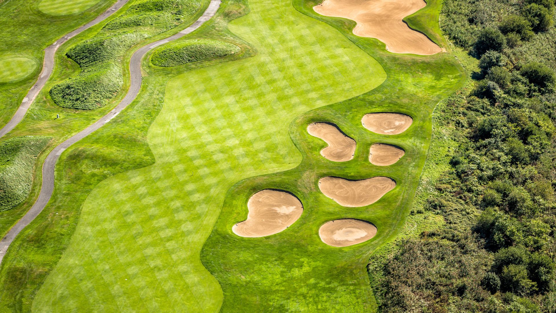 An aerial view of a green golf course